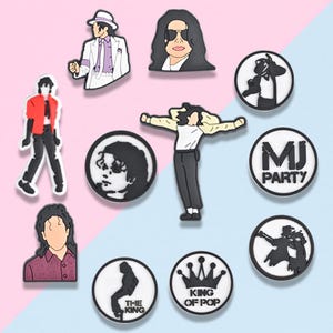 May include: A collection of black and white shoe charms featuring images of Michael Jackson in various poses and styles. Some charms include text such as "MJ PARTY" and "KING OF POP".
