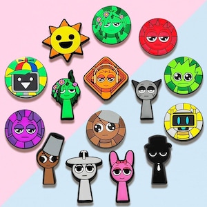 May include: A collection of colorful cartoon character charms in various shapes, including circles, squares, and figures. The charms feature a variety of designs, such as a smiling sun, a robot, and a cat. The background is a split of pink and blue.