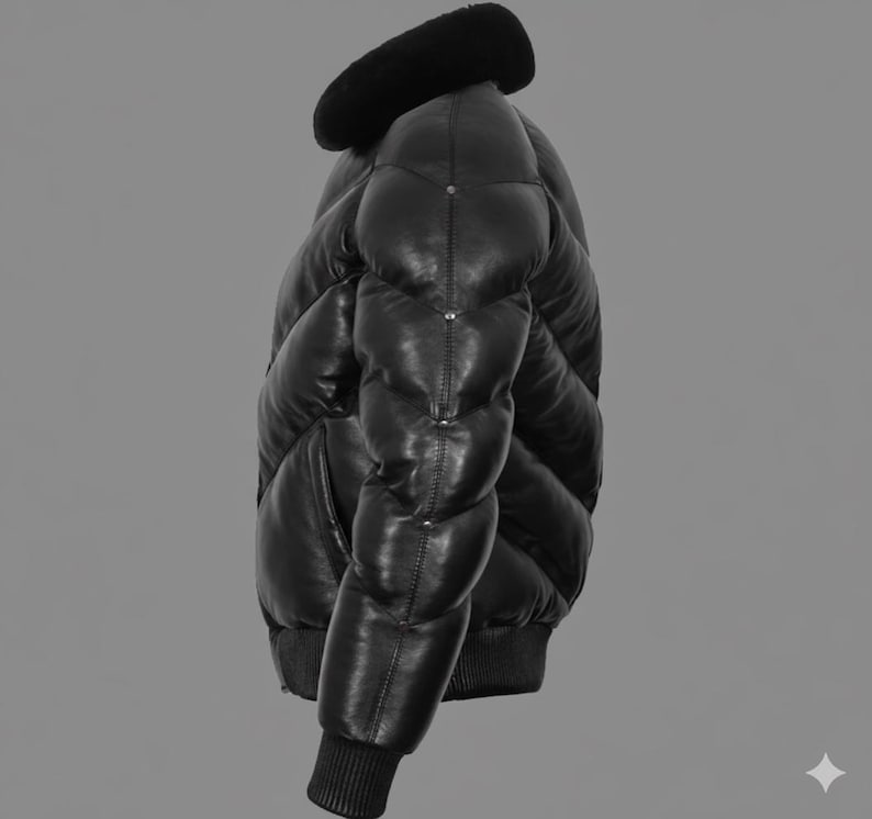 May include: Black leather puffer jacket with a black faux fur collar. The jacket has a quilted design, ribbed cuffs, and a ribbed hem. The jacket is a medium weight and appears to be a winter coat.