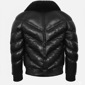 May include: Black leather puffer jacket with a plush, black collar. The jacket has a ribbed hem and cuffs, and a quilted design with a chevron pattern. The back view shows the jacket's padded construction.