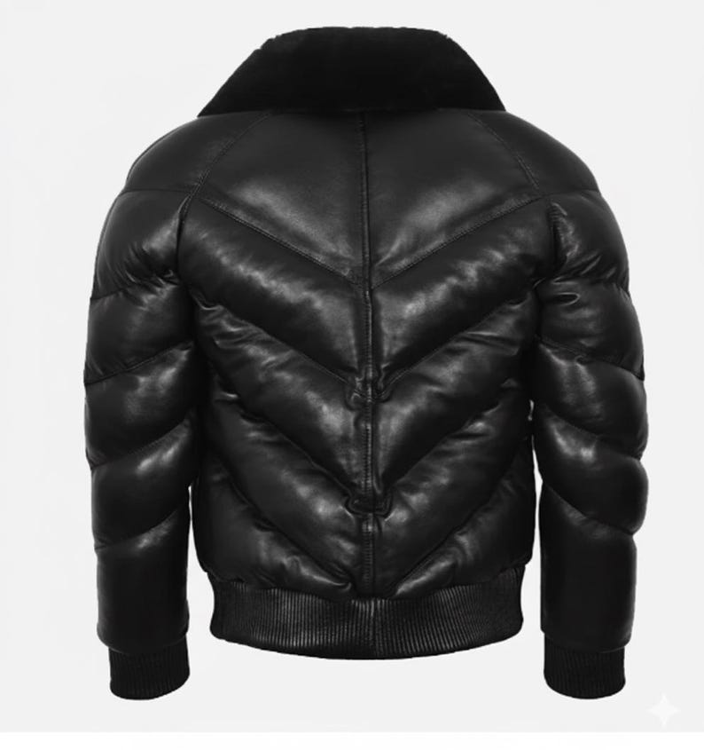 May include: Black leather puffer jacket with a plush, black collar. The jacket has a ribbed hem and cuffs, and a quilted design with a chevron pattern. The back view shows the jacket's padded construction.