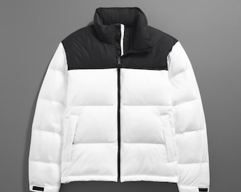 May include: A white and black puffer jacket with a high collar and a full-length zipper. The jacket is divided horizontally, with a black upper section and a white lower section. The jacket has a quilted design.