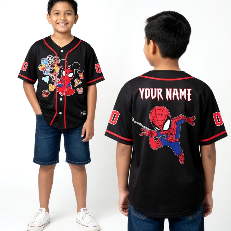 A young boy wearing a black baseball jersey with a Spiderman design and the text "YOUR NAME" printed on the back.