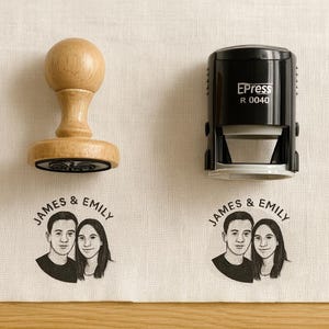 May include: A wooden stamp with a round handle and a black ink pad, next to a black self-inking stamp. Below are two fabric samples with a black and white illustration of a couple and the text "JAMES & EMILY".