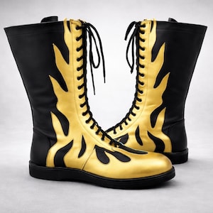 May include: Black and gold knee-high boots with a flame pattern. The boots have a lace-up design and a flat sole. The gold flames are a striking feature on the front and sides of the boots.