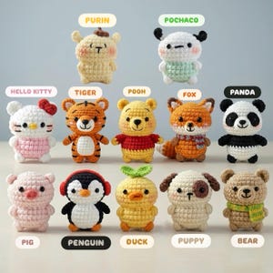 May include: A collection of twelve crocheted stuffed animals, each with a unique design. Characters include Hello Kitty, Winnie the Pooh, a panda, a fox, a tiger, a penguin, a duck, a puppy, a bear, and other cartoon characters. Each figure is labeled with its name.