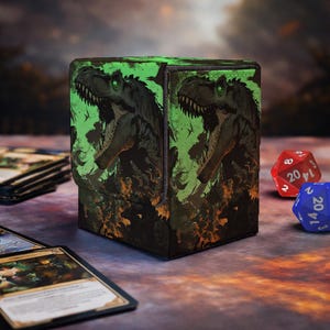 May include: A rectangular deck box featuring a graphic illustration of a dark green Tyrannosaurus Rex with glowing eyes against a vibrant lime green and orange background. The box has a textured surface and a flap closure, displaying a fierce dinosaur.