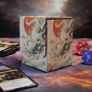 May include: A rectangular deck box for trading cards featuring a printed illustration of a white fox with red markings against a red sun and dark clouds. The box has a textured fabric-like finish and a magnetic flap closure on the front side.