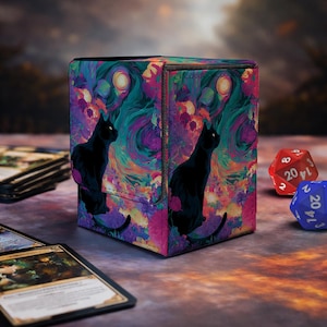 May include: A rectangular deck box featuring a vibrant, swirling abstract pattern in shades of purple, teal, and orange, with a black cat silhouette on the front and side panels. The box has a magnetic closure and a textured, fabric-like finish.