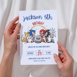 May include: A white birthday invitation card with the text "jackson 5th BIRTHDAY" in blue and red. The card features cartoon characters and a birthday cake. The invitation includes the date, time, and location for a "SONIC SUPER PARTY".