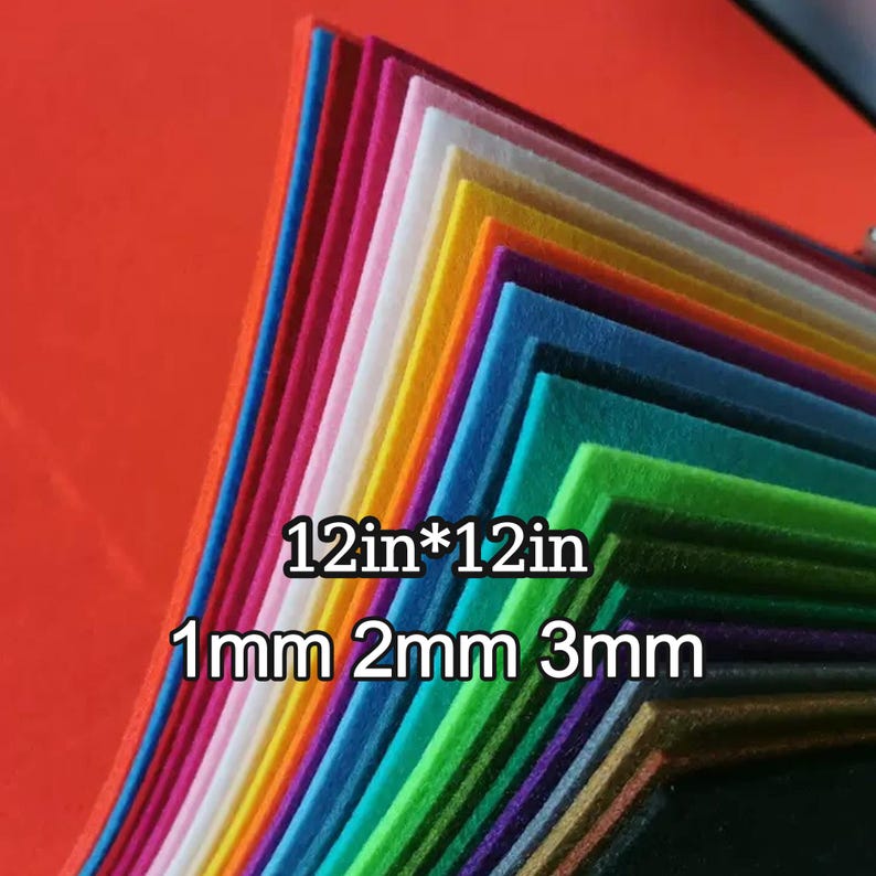 May include: A collection of multi-coloured felt sheets, including red, pink, yellow, and green. Each sheet measures 30.48 cm by 30.48 cm and is available in 1mm, 2mm, and 3mm thicknesses. The felt is stacked in a neat, angled pile.