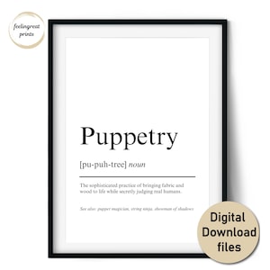 May include: A framed print with the word "Puppetry" in a bold, black font. The definition of puppetry is below the word. The print also includes the text "feelingreat prints" and "Digital Download files" in a circular design.