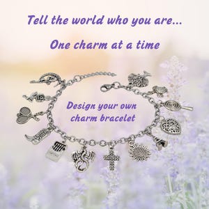 May include: A silver-toned metal chain charm bracelet featuring various dangling charms including a dragon, cross, sunflower, cowboy boot, tennis rackets, and rose. The text reads: Tell the world who you are... One charm at a time. Design your own charm bracelet.