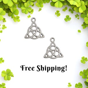 May include: Two silver-colored Celtic knot charms with a triangular design, each featuring a loop at the top for hanging. The charms are set against a white background with green shamrocks and the text "Free Shipping!"
