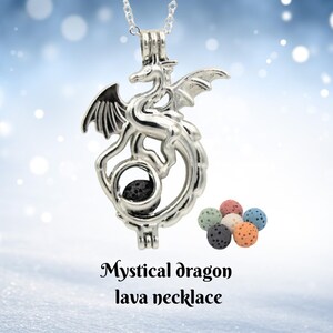 May include: A silver-colored dragon pendant necklace with a black lava stone inside. The dragon has detailed wings and a curled tail. Several colorful lava stone beads are displayed next to the necklace. The text "Mystical dragon lava necklace" is at the bottom.