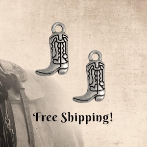 May include: Two silver-colored cowboy boot charms with intricate detailing. Each charm has a loop at the top for easy attachment. The boots are set against a sepia-toned background, evoking a rustic, Western theme.