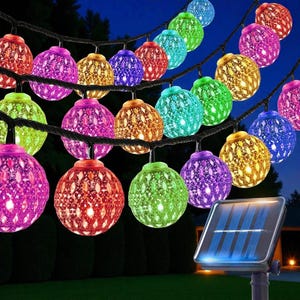 May include: String of colorful, globe-shaped solar-powered lights. Each globe has a patterned design and emits a vibrant glow in shades of red, purple, green, blue, and yellow. The lights are strung on a black wire, perfect for outdoor decor.