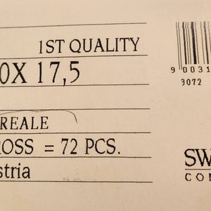 May include: A white label with black text that reads "6202 1ST QUALITY M 18,0X 17,5 CRISTAL AURORE BOREALE 00/06/00 GROSS = 72 PCS. Made in Austria" and a barcode with the text "9 003140 258271 > 3072 IMPINT" below it. The label also features a black and white Swarovski logo with the text "SWAROVSKI COMPONENTS".