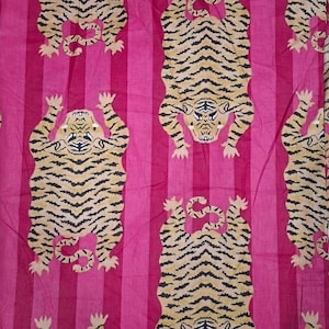 May include: A fabric textile featuring a repeating pattern of tan tigers with black stripes arranged in a vertical orientation, set against a background of alternating light pink and dark magenta vertical stripes throughout the material.