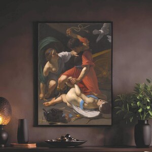 May include: A framed oil painting depicting a classical scene with figures in red and white robes, displayed above a dark brown slatted sideboard. A textured lamp, a black vase, and a bowl sit on the sideboard next to a green potted plant.
