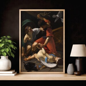 May include: A framed wall art print depicting a dramatic scene with a figure in a red tunic holding a whip over a reclining figure with white wings, while a woman in a blue and white garment looks on, set against a dark background.