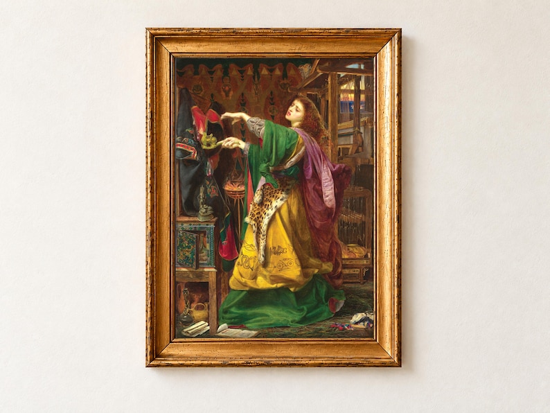Morgan le Fay by Frederick Sandys, 1864, as a framed print in an antique gold frame on a cream wall. The red-haired enchantress in a green and yellow robe raises a magic cloth as she casts a spell before her loom and shelves of potions.