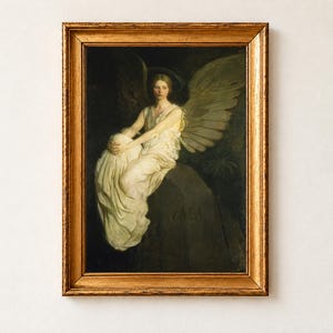 Stevenson Memorial by Abbott Handerson Thayer, 1903, as a framed print in an antique gold frame on a cream wall. A winged angel in flowing white robes sits on a stone carved with the word Vailima, keeping watch in memory of Robert Louis Stevenson.