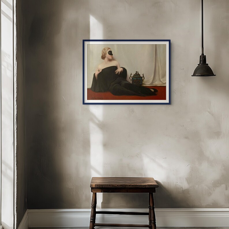 May include: A framed wall art print featuring a person wearing a black mask and a long black garment, reclining on a red surface against a white draped background. Beside the person sits a dark, ornate vessel with two handles.