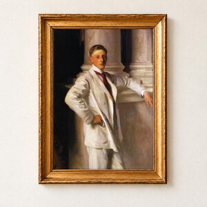 The Earl of Dalhousie by John Singer Sargent, 1900, as a framed print in an antique gold frame on a cream wall. A dark-haired boy in a cream suit and red tie stands confidently with one hand on his hip, leaning against a marble column.