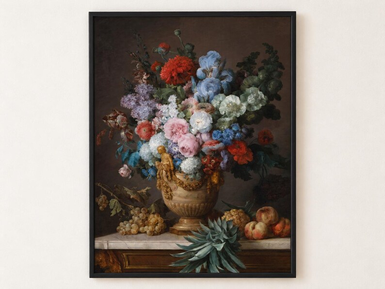 A framed oil painting depicting a large floral arrangement in a decorative beige urn, featuring red, blue, pink, and white flowers. Grapes, peaches, and a pineapple are arranged on a marble surface below the urn.