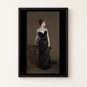 May include: A framed art print of a painting depicting a person with reddish-brown hair in an updo, wearing a floor-length black strapless gown with thin straps. The person stands beside a small wooden table against a muted brown background.