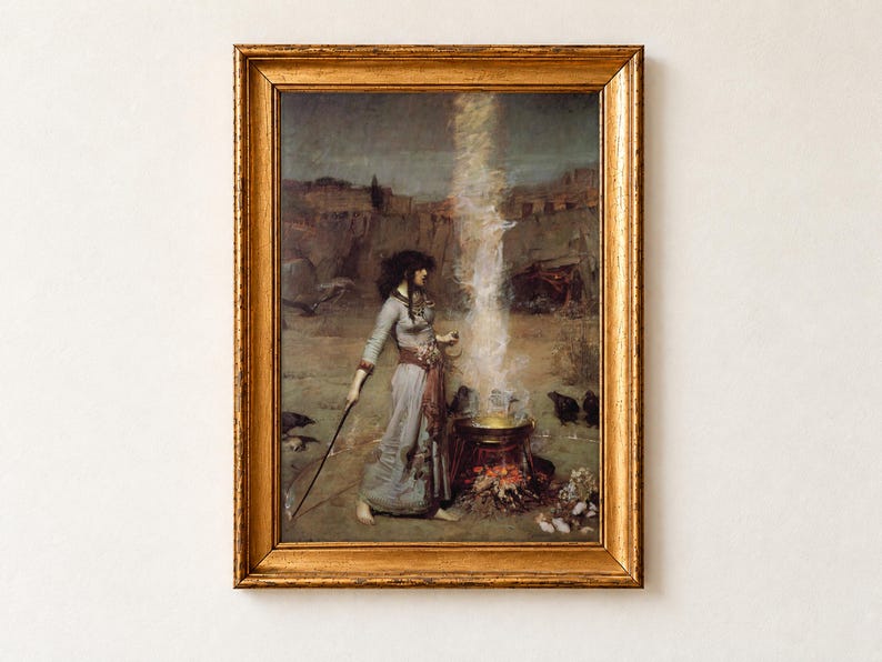 The Magic Circle by John William Waterhouse, 1886, as a framed print in an antique gold frame on a cream wall. A dark-haired sorceress traces a protective circle in the earth with a wand as smoke rises from a cauldron, ravens and a frog gathered at its edge.
