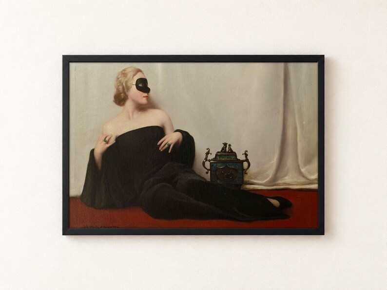 A framed oil painting depicting a blonde figure wearing a black domino mask and a long black gown, reclining on a red surface. Beside the figure sits a small, ornate, dark-coloured decorative vessel with metallic handles.