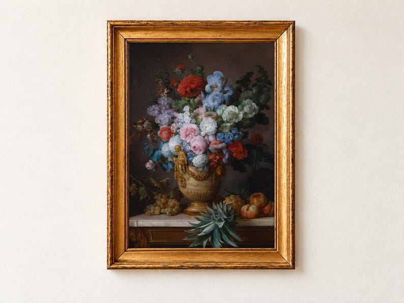 Still Life with Flowers in an Alabaster Vase and Fruit by Anne Vallayer-Coster, 1783, as a framed print in an antique gold frame on a cream wall. Red poppies, blue irises, pink roses and a striped tulip spill from an alabaster vase hung with gilded garlands, beside grapes, peaches and a pineapple on a marble table.