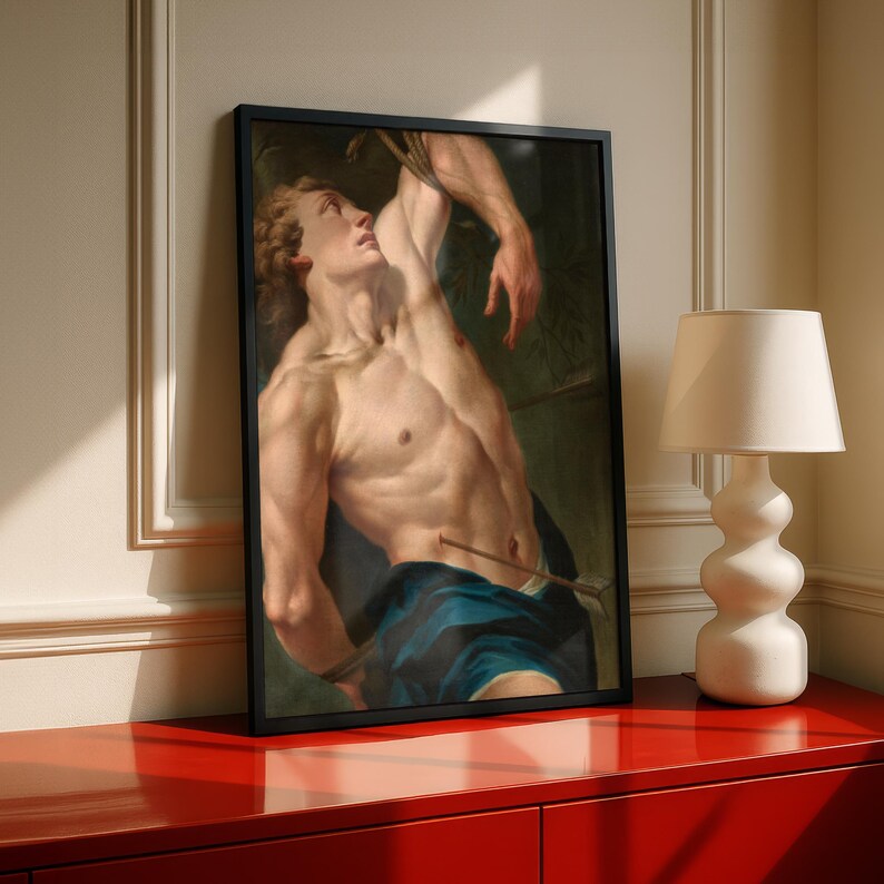Saint Sebastian Martyr painting in a black frame on a red sideboard with a lamp