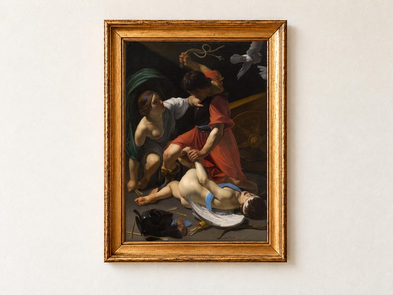 Cupid Chastised by Bartolomeo Manfredi, 1613, as a framed print in an antique gold frame on a cream wall. Mars in a red cloak raises a whip over a winged Cupid pinned to the ground, while Venus reaches out to stop him, with Cupid's bow, arrows and Mars's armour scattered below and white doves above.