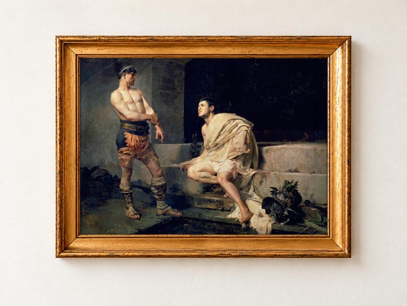 Gladiators after the Combat by José Moreno Carbonero, 1882, as a framed print in a gold frame. Two gladiators rest in a dim stone passage, one standing by an inscribed pillar and one seated on the steps with a pale cloth around his shoulders.