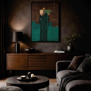 May include: A framed wall art print depicting a figure in a dark green robe holding a shallow bowl from which a vibrant green liquid pours downward into a pool of the same color, set against a dark, textured, and moody background.