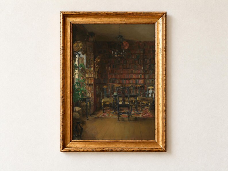 The Library of Thorvald Boeck by Harriet Backer, 1902, as a framed print in an antique gold frame on a cream wall. A quiet home library lined floor to ceiling with books, with carved wooden chairs around a table, a hanging chandelier and green plants by a sunlit window.