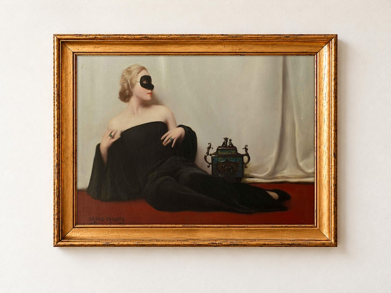 The Mask by Bruno Croatto as a framed print in an antique gold frame on a cream wall. A blonde woman in a black wrap and black eye mask reclines on a red floor beside a gilded incense burner, against a white silk curtain.