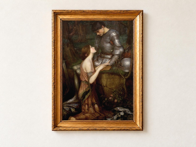 Lamia by John William Waterhouse, 1905, as a framed print in an antique gold frame on a cream wall. A kneeling woman with a snakeskin draped over her gown gazes up at a knight in silver armour in a shadowy forest.