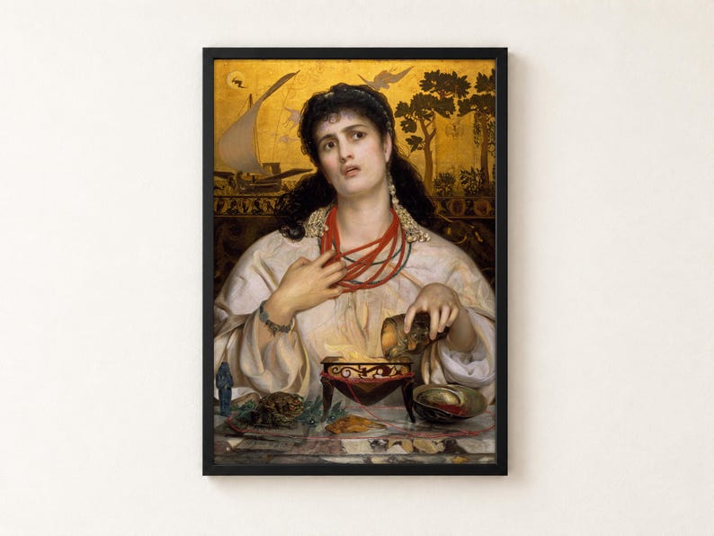 Medea by Frederick Sandys, 1868, as a framed print in a black frame on a cream wall. A dark-haired woman in a white robe and coral necklaces pours a potion into a glowing brazier, with the ship Argo and the Golden Fleece painted on a gold background behind her.