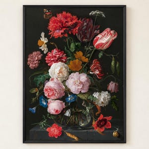 May include: A framed wall art print featuring a dark, moody floral arrangement in a glass vase. The bouquet includes vibrant red, pink, white, and orange flowers, green foliage, a small butterfly, and a snail on a stone ledge against a black background.
