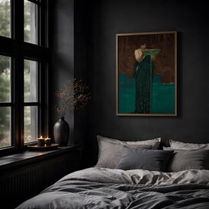 May include: A framed wall art print depicting a figure in a dark green robe holding a bowl with green liquid, displayed in a bedroom with gray bedding, a black vase with dried branches, and two lit candles on a window ledge.