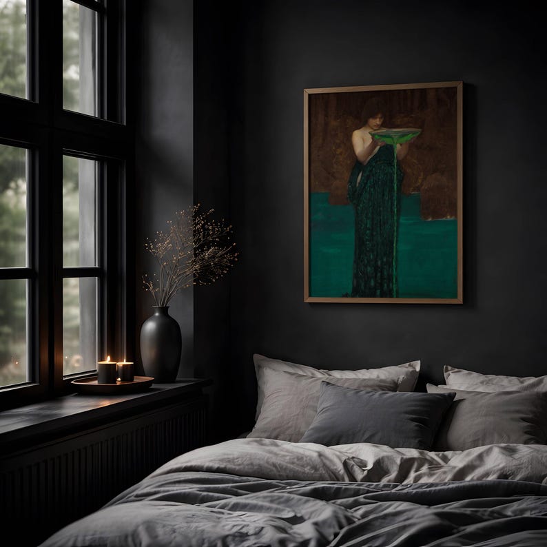 May include: A framed wall art print depicting a figure in a dark green robe holding a bowl with green liquid, displayed in a bedroom with gray bedding, a black vase with dried branches, and two lit candles on a window ledge.