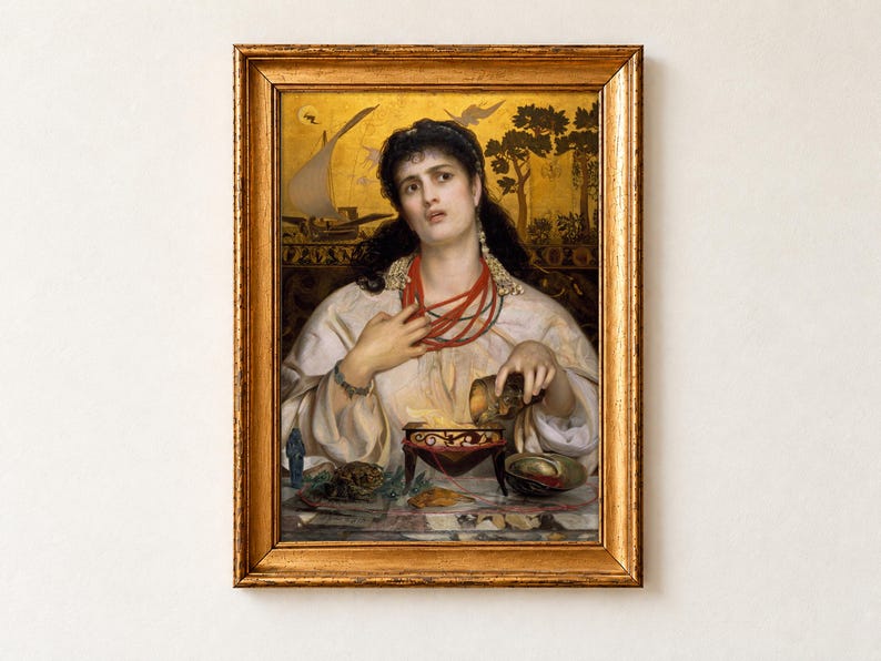 Medea by Frederick Sandys, 1868, as a framed print in an antique gold frame on a cream wall. The dark-haired sorceress clutches her red coral necklace as she prepares a potion in a bowl, set against a gold background painted with a ship.