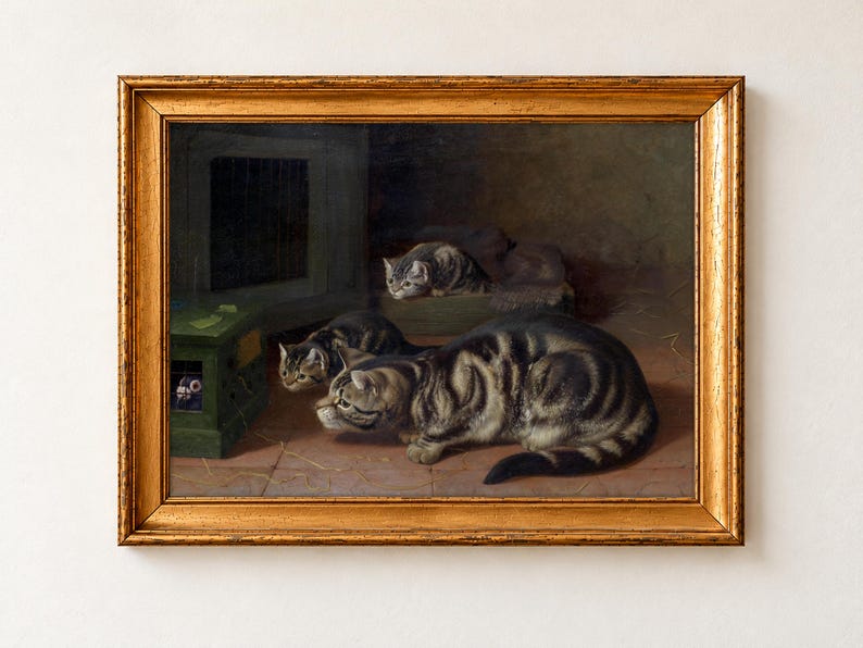 Curiosity by Horatio Henry Couldery as a framed print in a gold frame. Three tabby cats crouch on a tiled floor, staring at a small green box with a barred window.