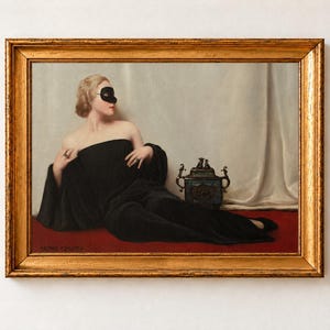 The Mask Print, Bruno Croatto Masquerade Portrait Wall Art, Old Money Femme Fatale Poster. A framed oil painting depicting a blonde figure wearing a black domino mask and a long black gown, reclining on a red surface. Beside the figure sits a small, ornate, dark-coloured decorative vessel with metallic handles.