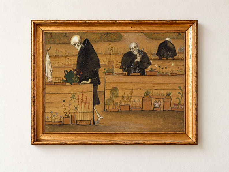 The Garden of Death by Hugo Simberg, 1896, as a framed print in an antique gold frame on a cream wall. Three skeletons in black hooded robes tend rows of potted flowers in a walled garden, one carrying a green watering can and one cradling a bunch of blue flowers.