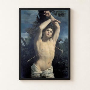 Saint Sebastian by Guido Reni, about 1615, as a framed print in a black frame on a cream wall. A young man with his wrists bound above his head to a tree looks up to the sky, pierced by two arrows, a white cloth at his hips, against blue sky and dark leaves.